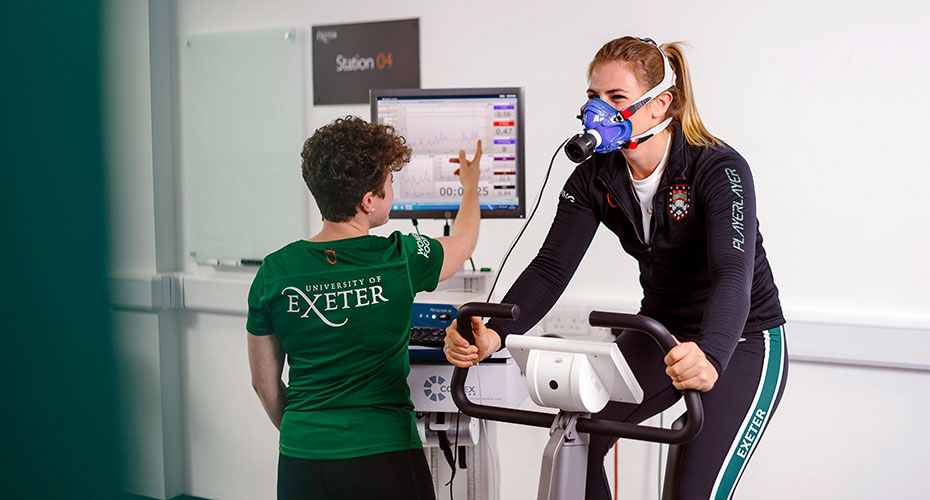 Two students conducting an experiment using a lode cycle ergometer